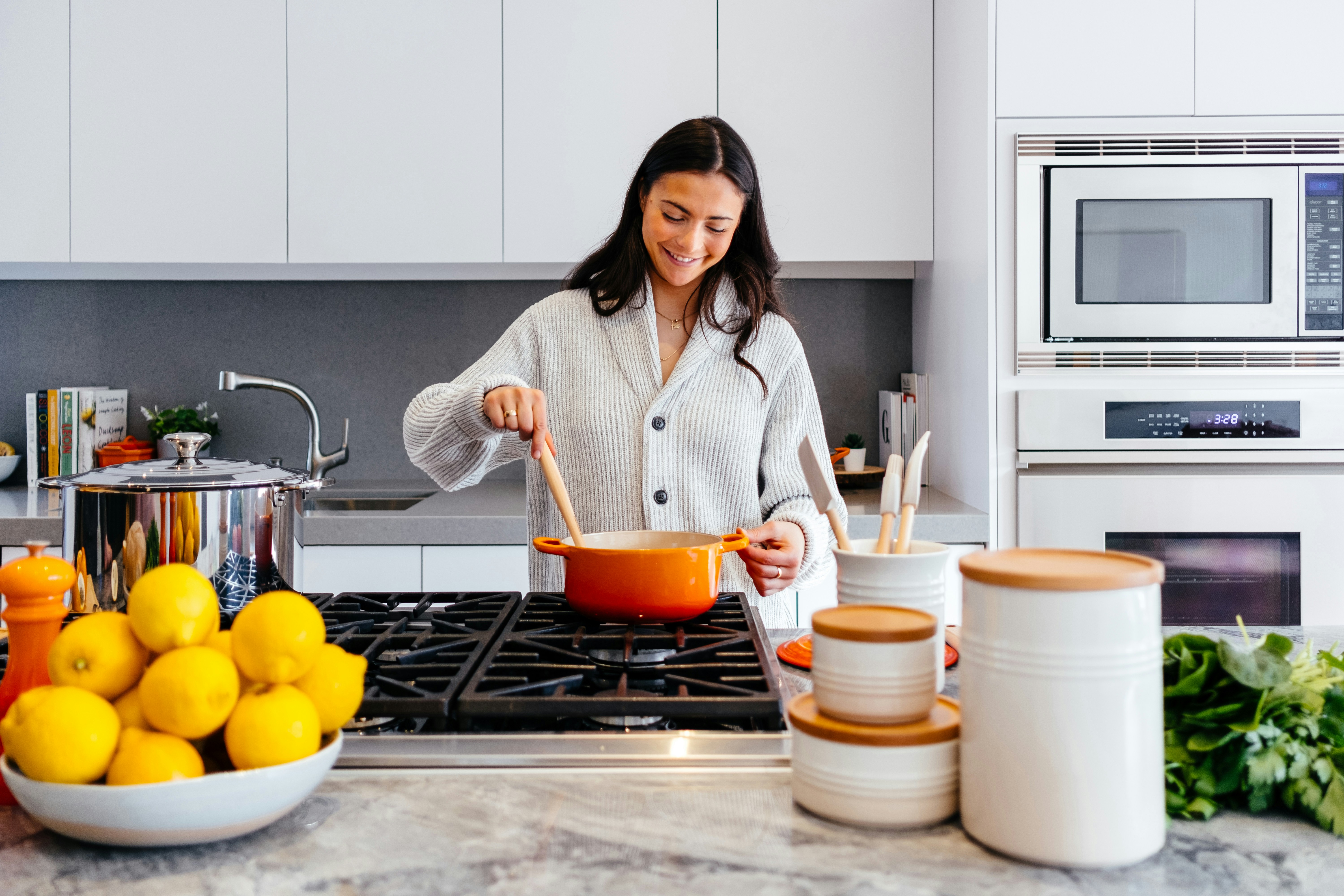 A woman preparing a meal in a bright kitchen