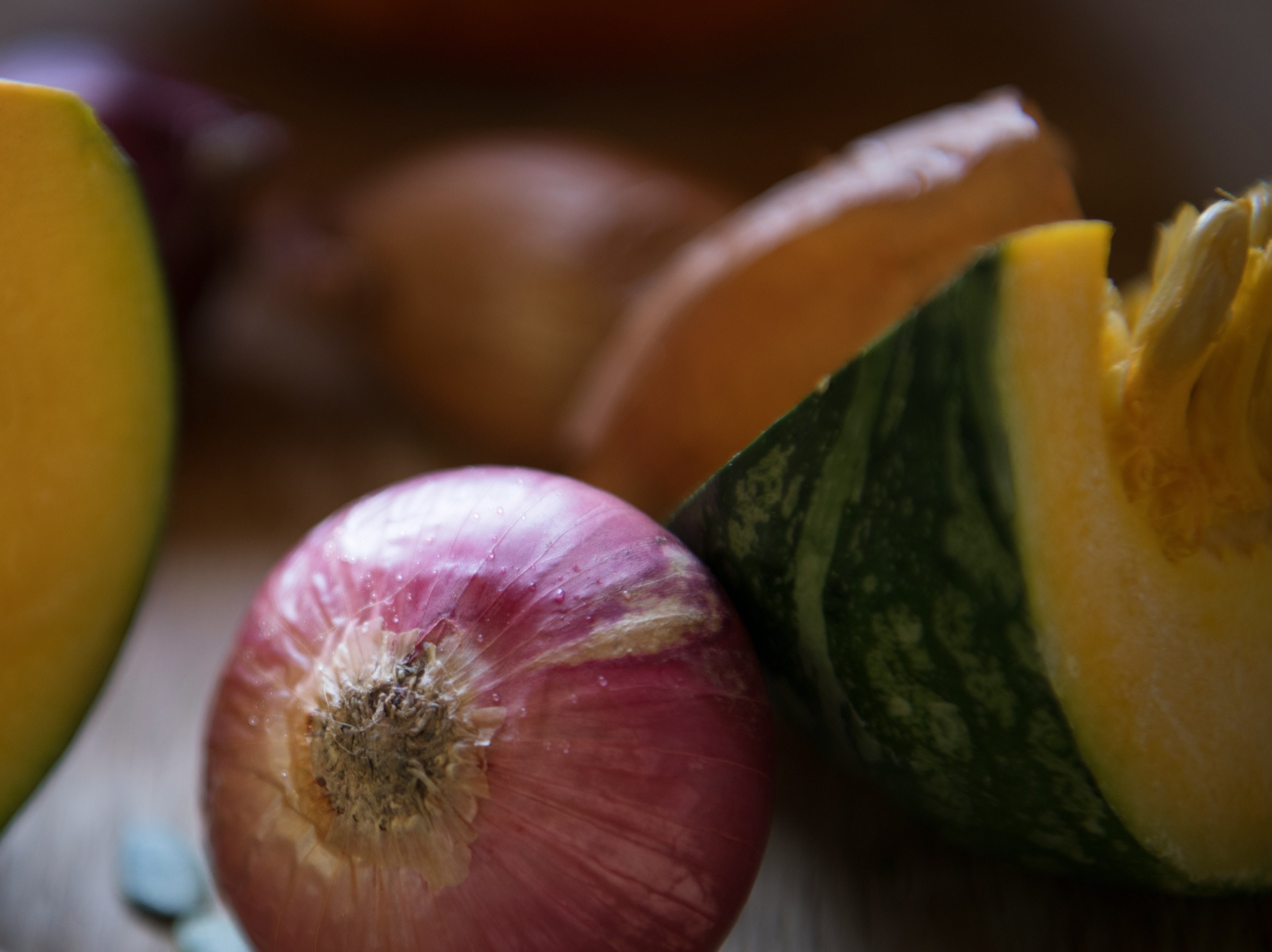 Fresh vegetables including an onion and squash